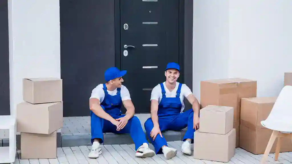 two men ready for a move, sitting on the front door