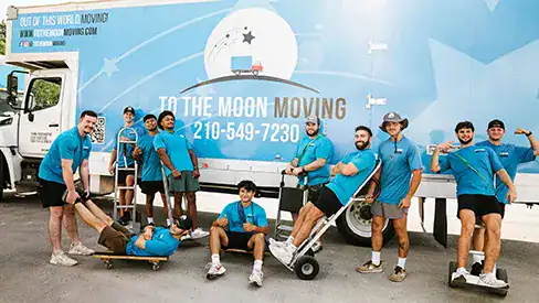 To the Moon Moving Company's crew posing for an image in front of To the Moon Moving mural